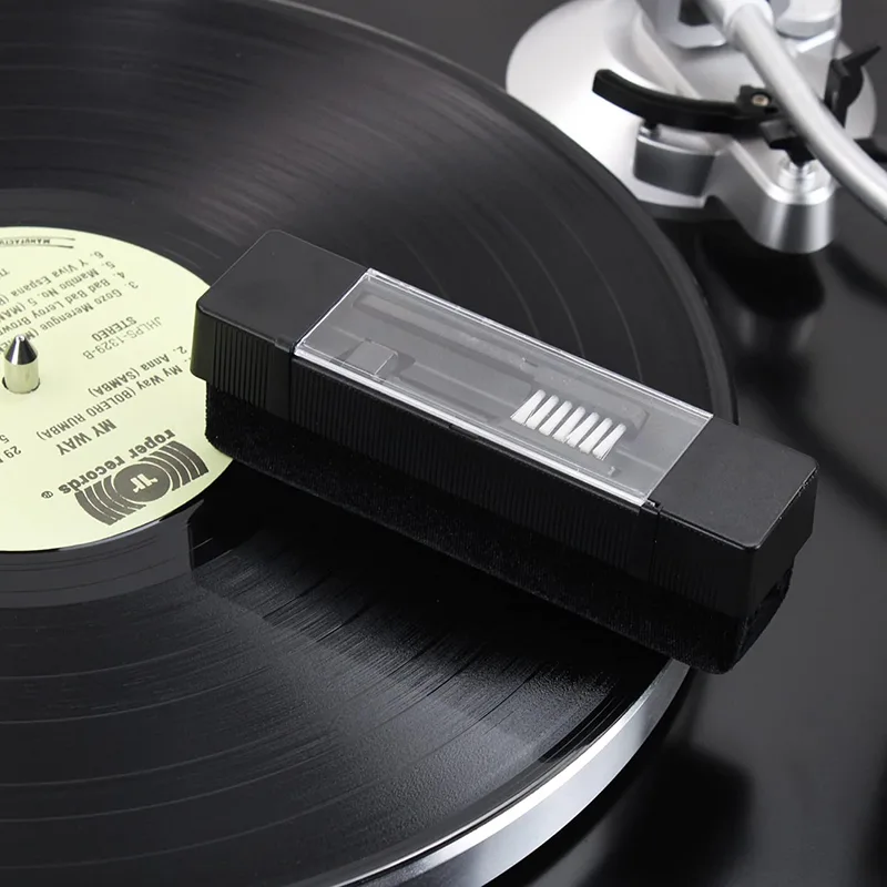 Velvet block resting on a record on a turntable platter, clear cover slid back